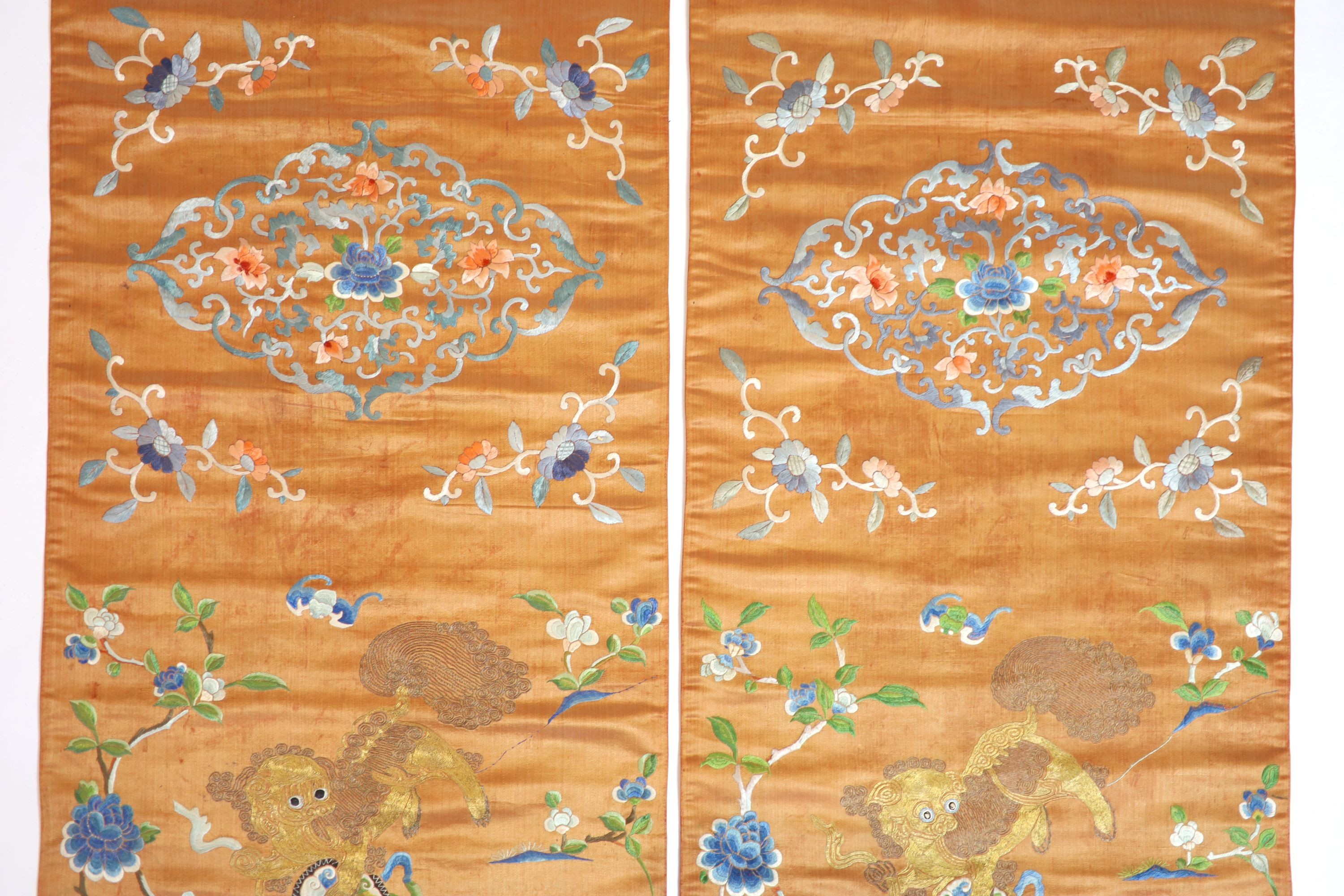 A pair of Chinese peach silk embroidered hangings, 19th century 137 x 44 cm